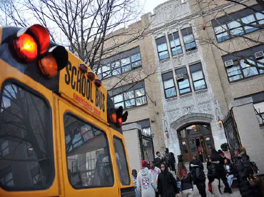 A school bus parked outside of a school.