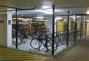 Bicylces stored in a secure gate enclosure.