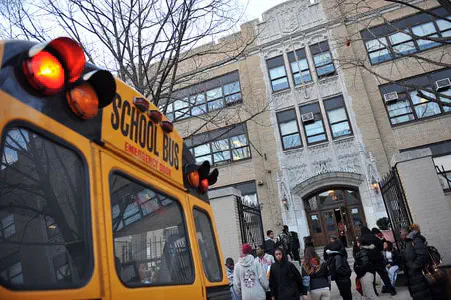 A school bus parked outside of a school.