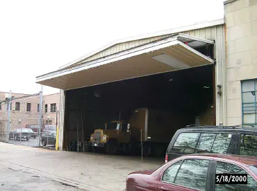 semi parked in garage with horizontal folding door open