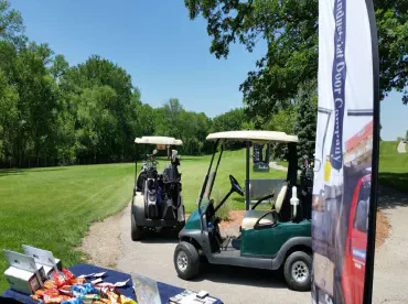 Golf carts at a tee box during a golf outing