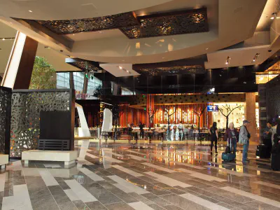 Large view of a hotel lobby with people waiting at the desk