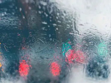 Interior of a car looking out the windshield that is covered in ice