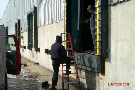 Men working on dock doors outside