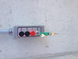 Garage door operating buttons with a key inserted to active it