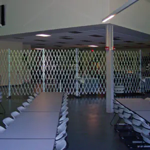 portable scissor gates installed in a cafeteria