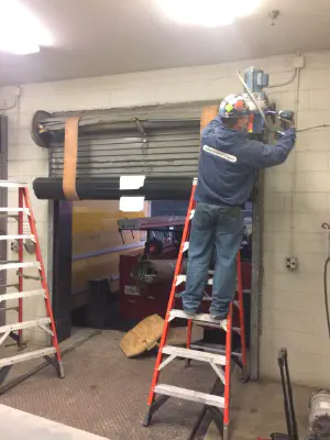 Repair man working on an overhead door