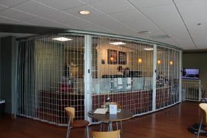 A interior coffee shop secured by a rolling grille while closed.