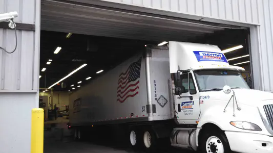 a semi truck exiting a garage