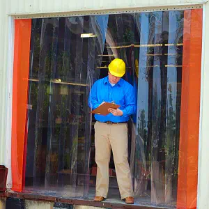 man standing in front of a vinyl strip door